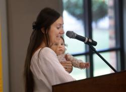 Damaris Truta Tina, December tornado victim sharing her story with the crowd at 2024 UWSC Community Impact Breakfast