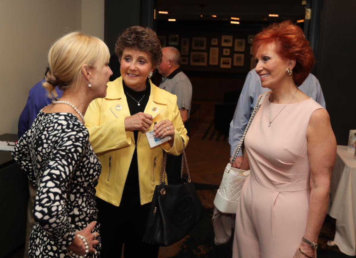 UWSC Board Chair Lindy Gaughan greets UWSC Board Member Grace Oliver and Rhonda Marko as they arrive at the Breakfast.