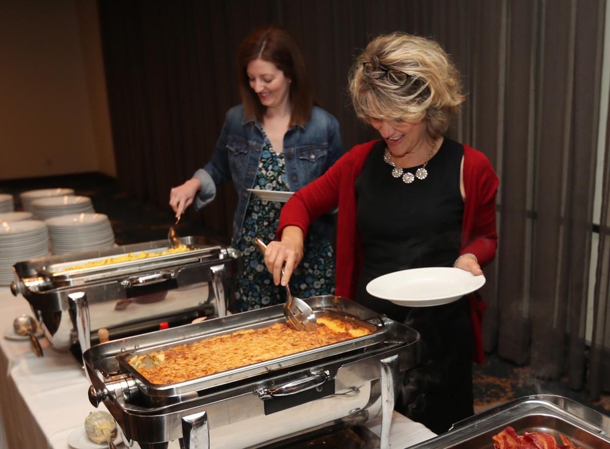 Guests go through the breakast buffet line at UWSC's annual Community Celebration Breakfast held on April 26 at Bluegrass Country Club in Hendersonville.