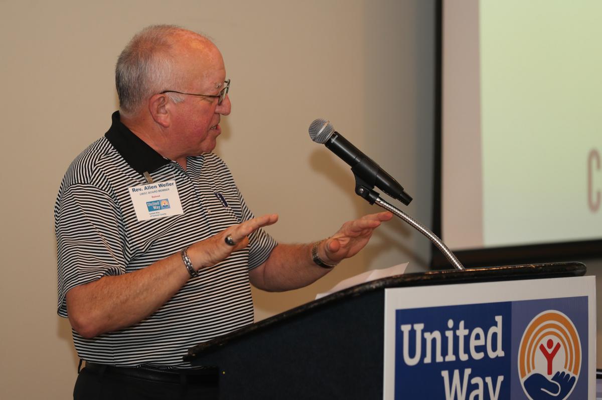 UWSC Board Member Rev. Allen Weller shares a story with the audience before leading the morning's invocation.