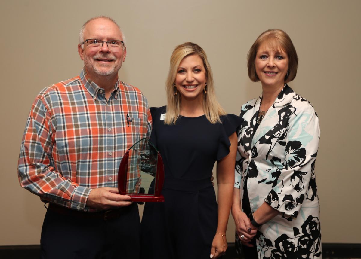 UWSC Chief Development Officer Erin Birch presents the 2018 Fundraiser of the Year Award to Bob Cotter and Debbie Sheets from Hendersonville High School. Including the $12,000 raised in 2018, the duo has spearheaded campaigns that raised more than $42,000 over the past five years.