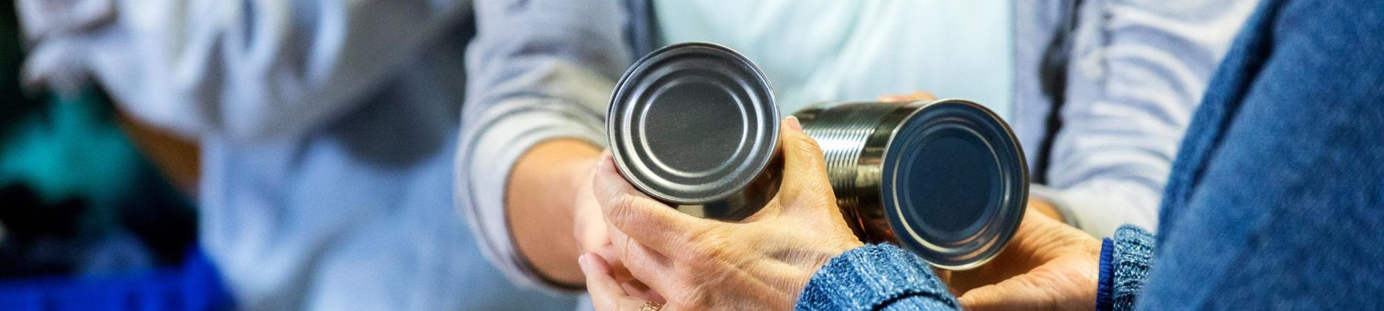 people passing out canned goods