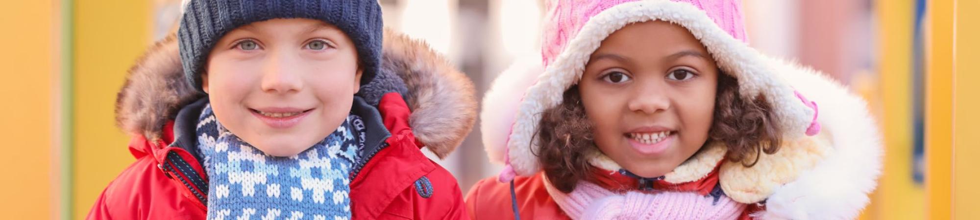 white boy and black girl in coats