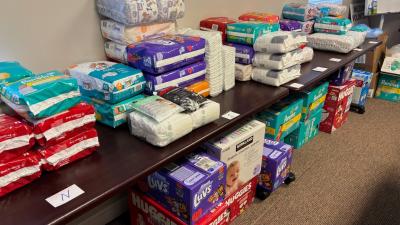 Piles of diapers donated for 2024 UWSC Mom & Baby Care Drive