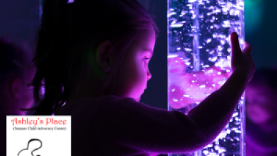 Little girl looking at purple lights
