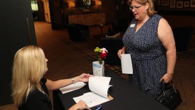 UWSC Finance Manager Danielle Robinson checks in guests at the Celebration Breakfast.