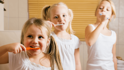 3 kids brushing teeth for Impacting Our Neighbors at Community Resource Center logo