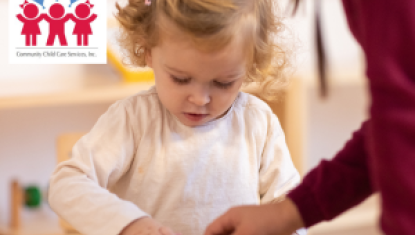 adult helping child with puzzle