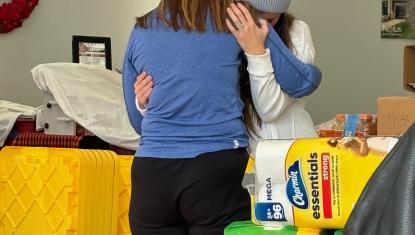 UWSC CEO Erin Birch hugs disaster victim