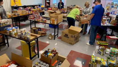 Volunteers sort food at 2022 United We Feed food drive